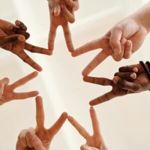 Multicultural hands forming a star shape symbolizing unity and teamwork.